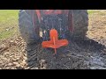 Ripping and tearing busting out roots with kubota m6060 and single shank ripper