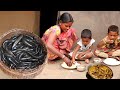 A santali tribe mother cooking small fish curry recipe for her childrens  bengali community life