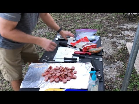 Overnight camp, cooking foil packs on campfire