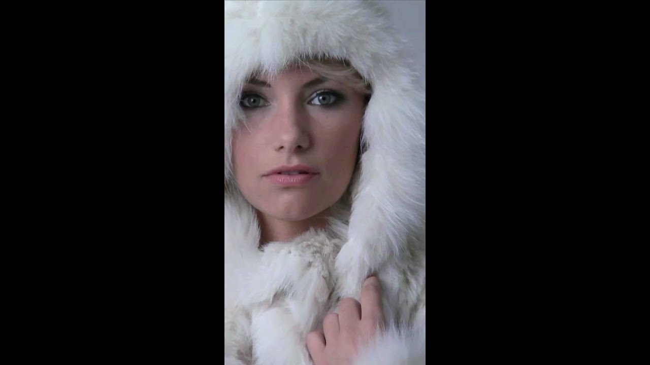 Lady in knitted fur coat with big fur hood