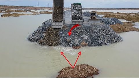 NEW Road Build by skill operator Modern machine bulldozer komatsu push big stone into water in lake