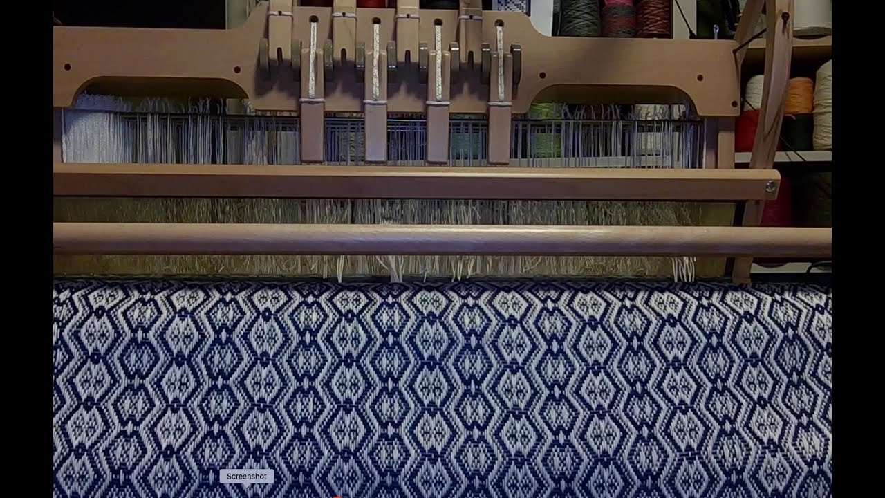 unrolling woven towels from Ashford 32-inch 8-shaft table loom