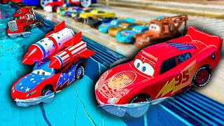 Disney Pixar Cars fall into the water: Lightning McQueen, Chick Hicks, Mack Trucks, Dinoco, Mater