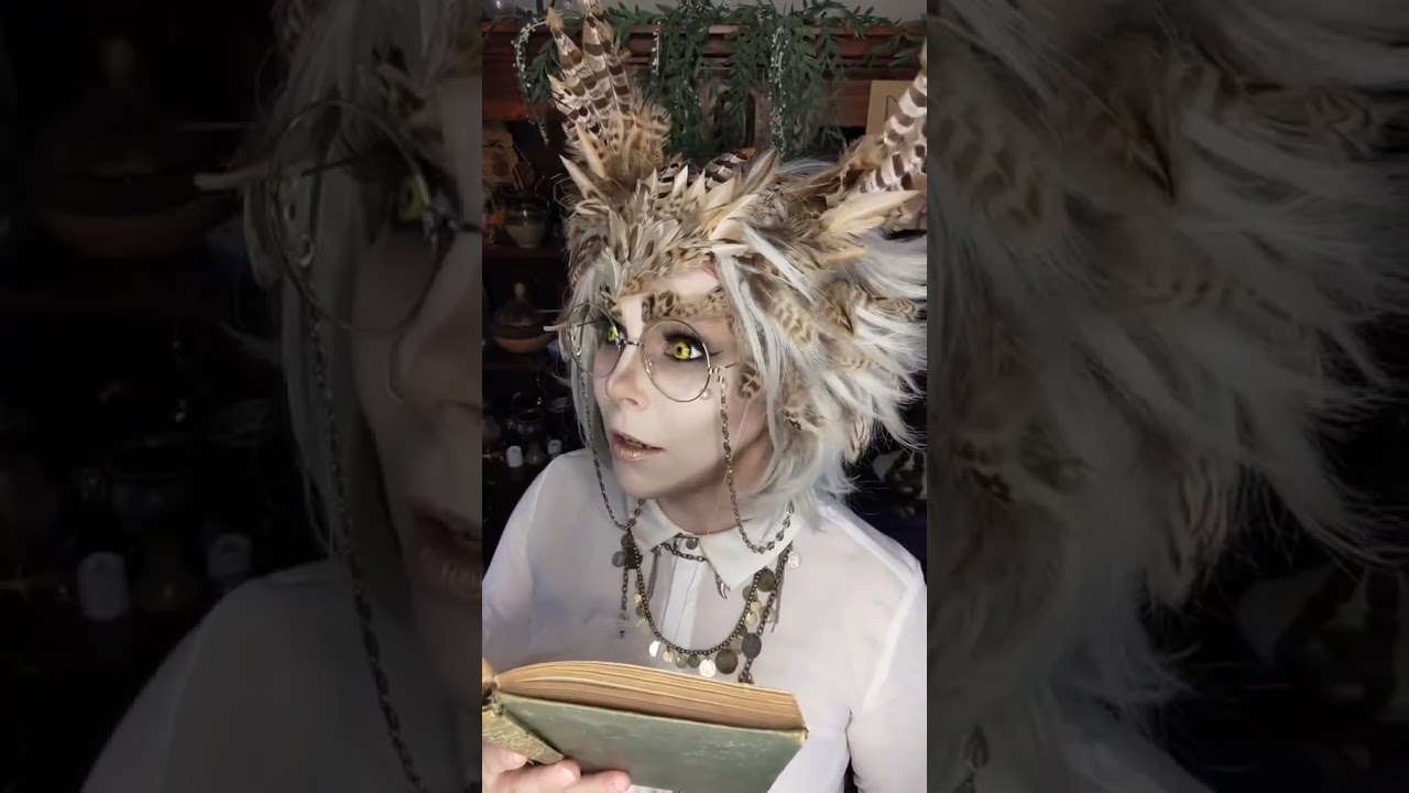 The Owlchemist Juniper reads a spicy book.