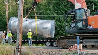 Large Culvert pipes being delivered and unloaded with excavator #smithroadconstruction