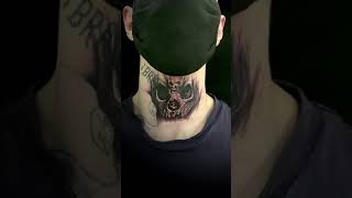 Skull neck tattoo