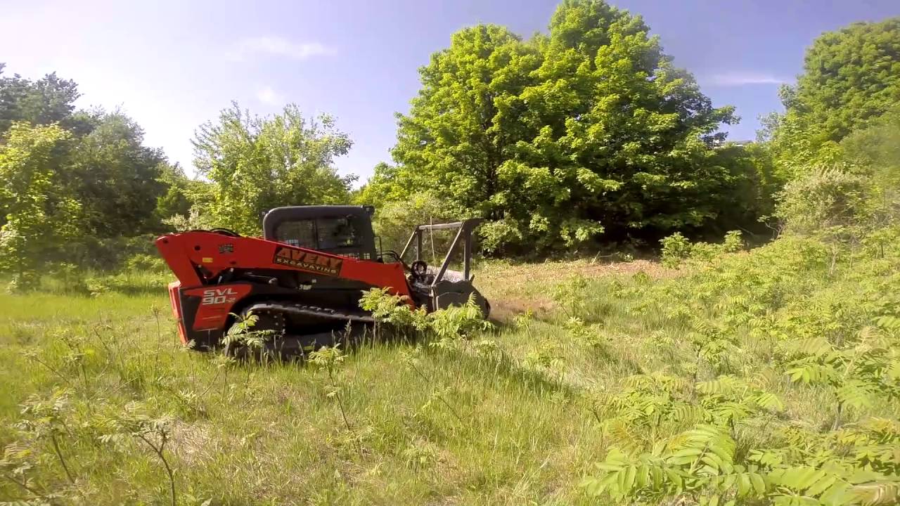 Kubota SLV90 2 with Bradco forestry mulcher clearing land YouTube