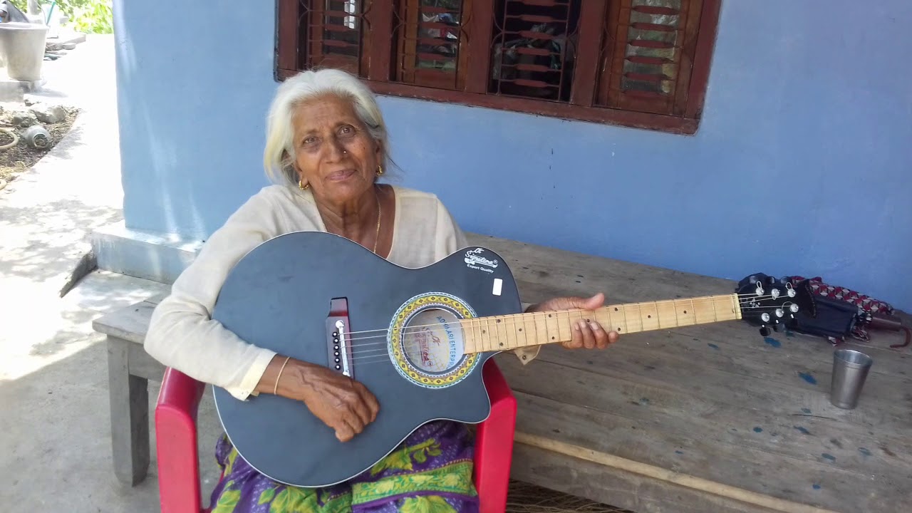A old women singing song with guitar