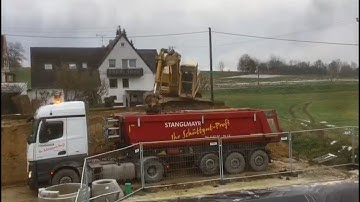 Caterpillar CAT 215D LC loads truck