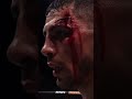 A cinematic close up of a fighter s swollen eye  blood trickling down his cheek  He raises his guard