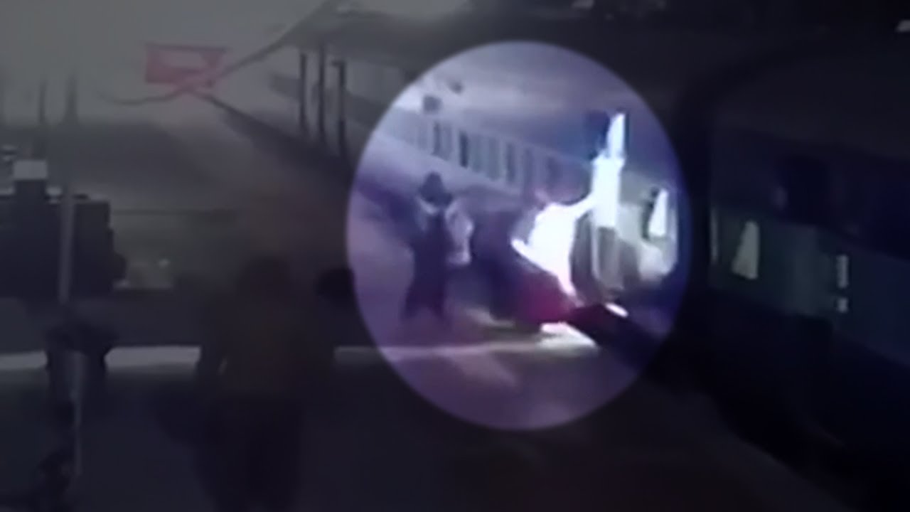 Onlookers rushed to rescue a woman slipping under a moving train
