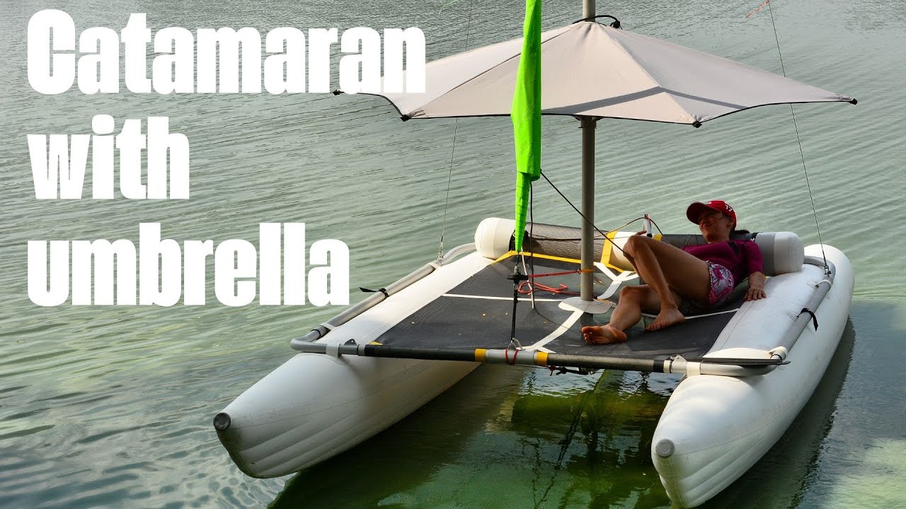 ⁣Inflatable sailing catamaran with umbrella
