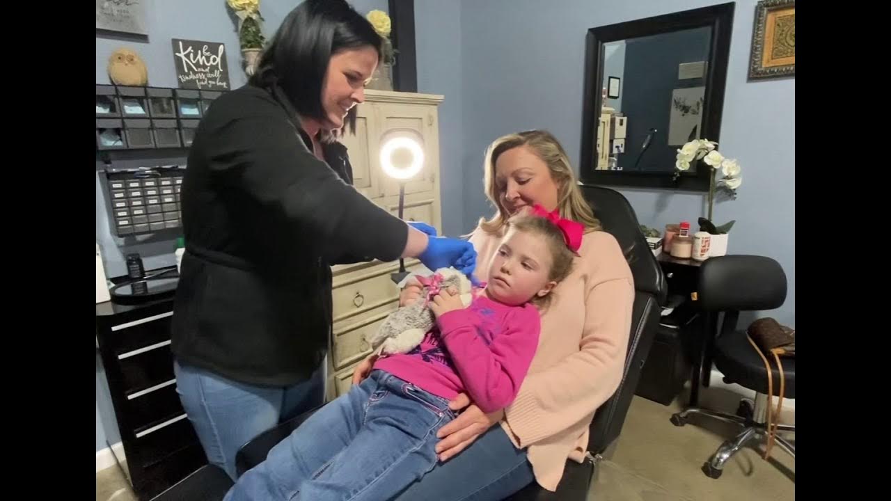 Kids Ear Piercing Our 5 year old getting her ears pierced at a Tattoo