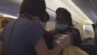 Incredible moment woman gives birth on a plane