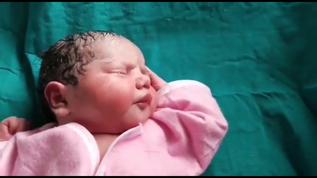 Healthy Newborn baby just after birth first time dress-up 