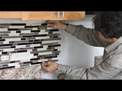 Install backsplash tile in kitchen