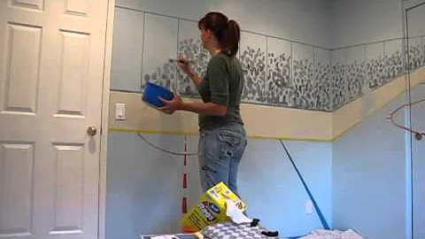Nancy Hadley painting a hockey rink mural crowd qu...