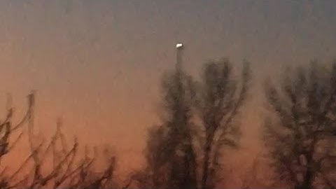 A freestanding cellphone tower with a backup night mode beacon, in Webster City, Iowa.
