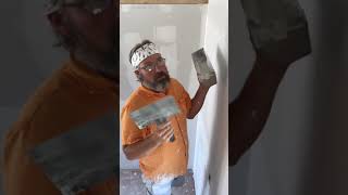 Mudding the butt joint seams when finishing drywall.