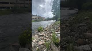 Big Thompson River flows past the visitor center parking garage in downtown Estes