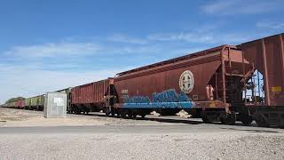 An empty BNSF grain train passing through Roswell NM with 1 ET44C4 leading