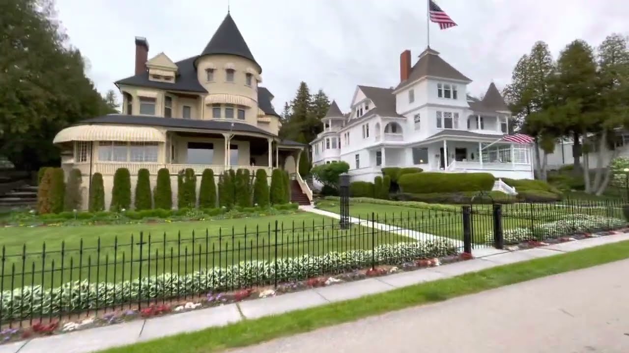The houses of the west bluff on Mackinaw island. Mackinaw bridge at the very end.. 