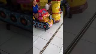 Three Friends Ride Kid Arcade Games as One Flips Back and They Run Away Laughing