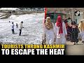 Tourists throng to Kashmir to enjoy snowfall &amp; escape the heat as Central India battles intense heat