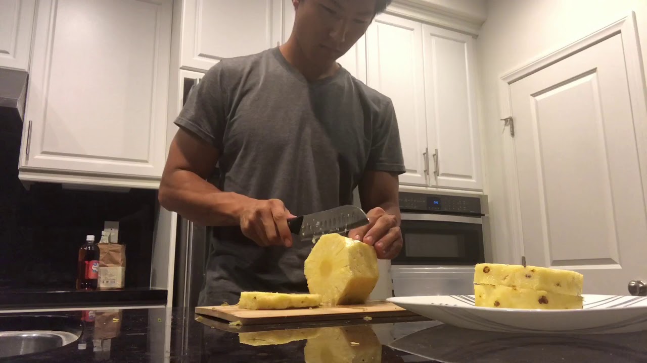 Asian guy shows you how cuts a pineapple set to jazz music
