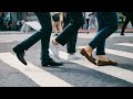 Pedestrians walking across urban street crosswalk - Stock Footage