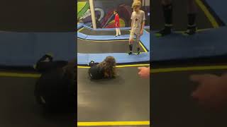 Little girl plays dodgeball at trampoline park and gets hit on the head by a ball