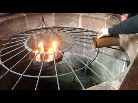 Pouring water down a 50 meter well.