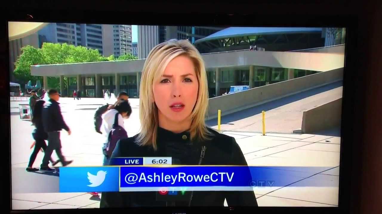 CTV news guy walks in front of Ashley Rowe, she's surprised. YouTube