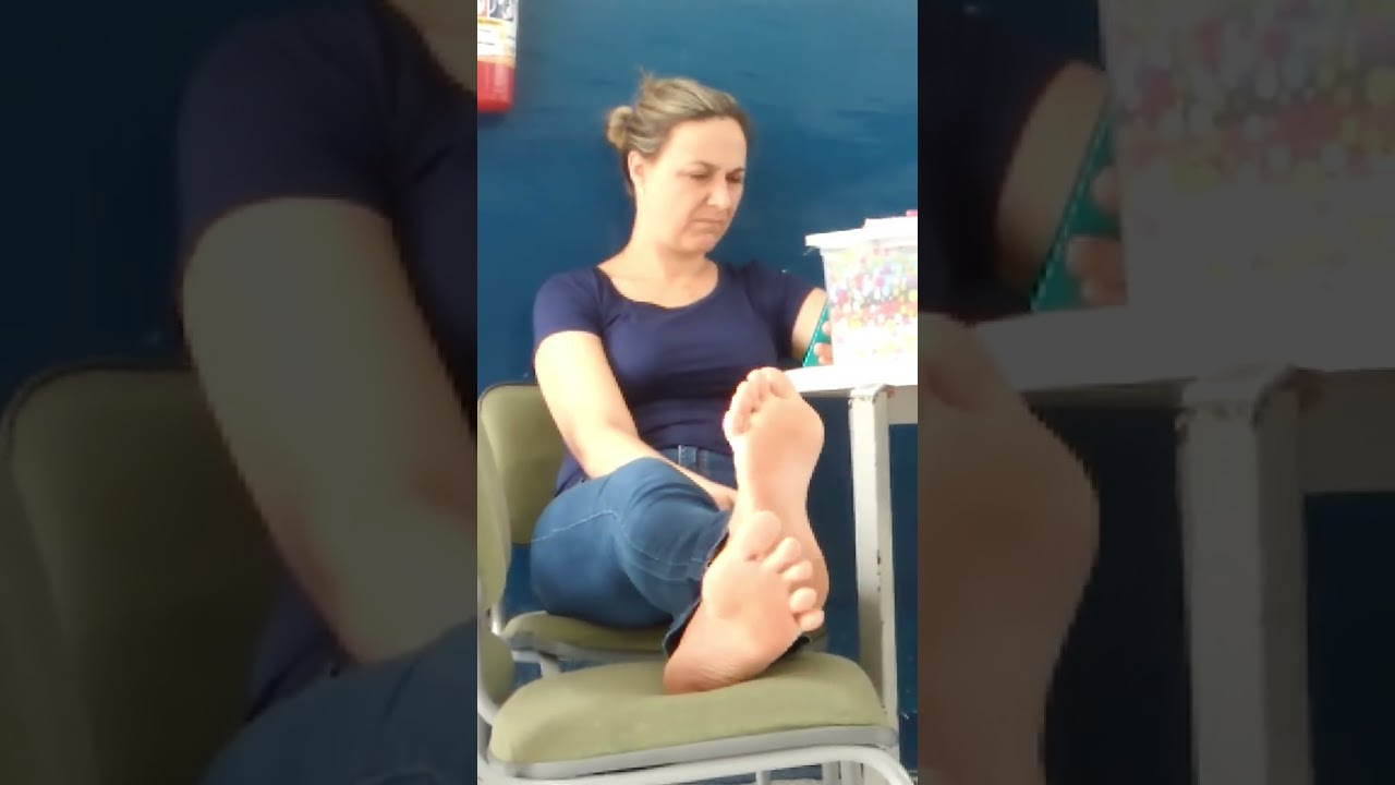 teacher goes barefoot during class and puts her feet up