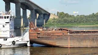Nizhny Novgorod, 08.07.2023. The Oka River. A barge with a tug is going down the river under the
