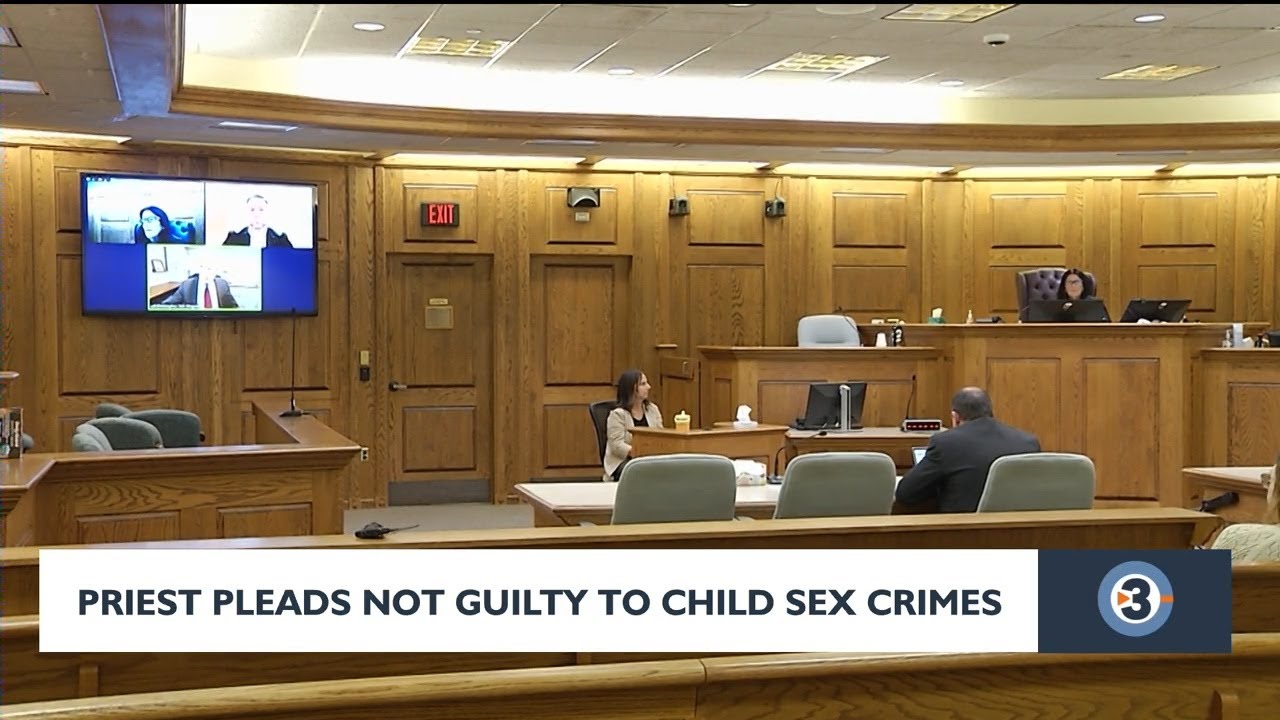 Priest pleads not guilty to child sex crime charges - YouTube