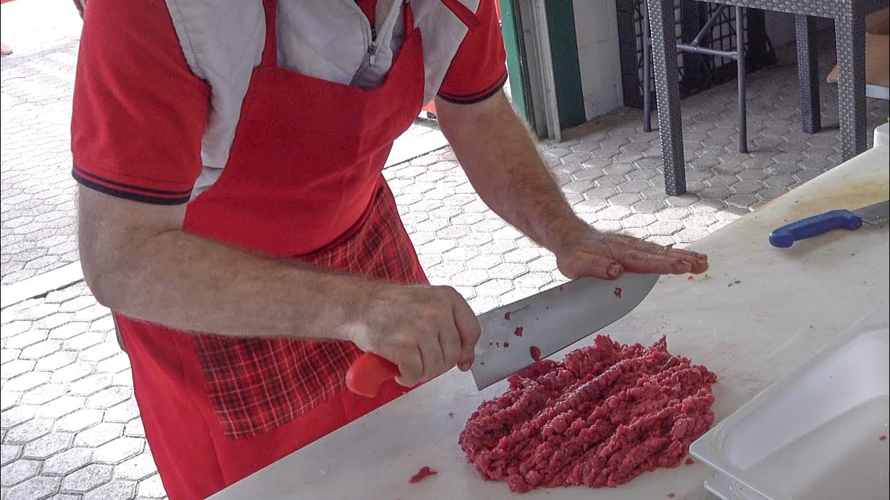 Italian Beef Minced by Hand with Sharp Knife. Street Food