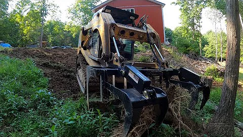 Using the root grapple and rock bucket on a job