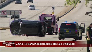 Bank robbery suspect booked into jail following chase and crash in Broward