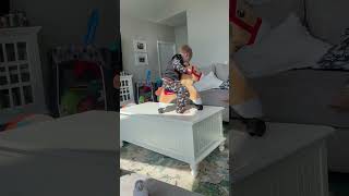 Boy rides horse with wheel off coffee table and faceplants on living room