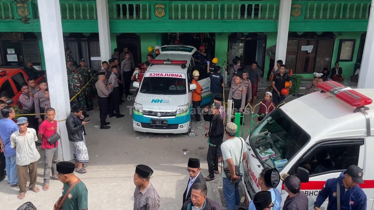 Rescuers run oxygen to survivors in Indonesia school building collapse that buried dozens