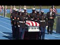 Solemn march as fallen Marine brought to service