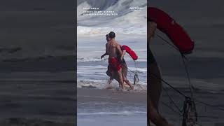 Wild video shows HEROIC LIFEGUARD rescuing boy from rough surf