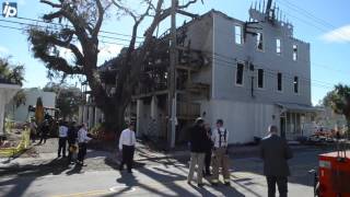 Investigators pore over the scene of the fire at the black chamber of commerce