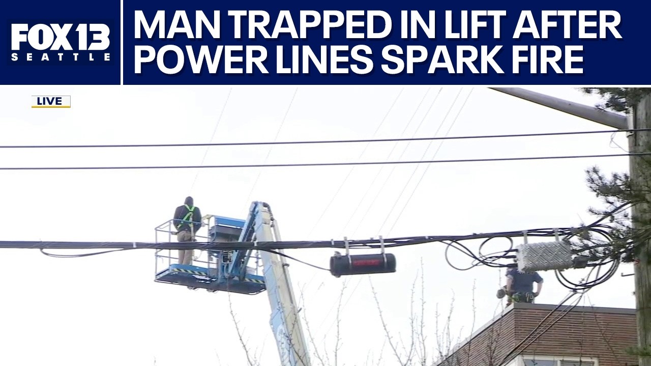 Man trapped in lift after power lines spark fire in Seattle - YouTube