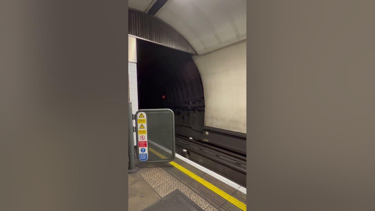EXTREME SPEED, London underground train approaches platform at high speed. EXTREME SPEED, London underground train approaches platform at high speed.