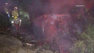 Firefighters Search For Victims After Fiery Crash