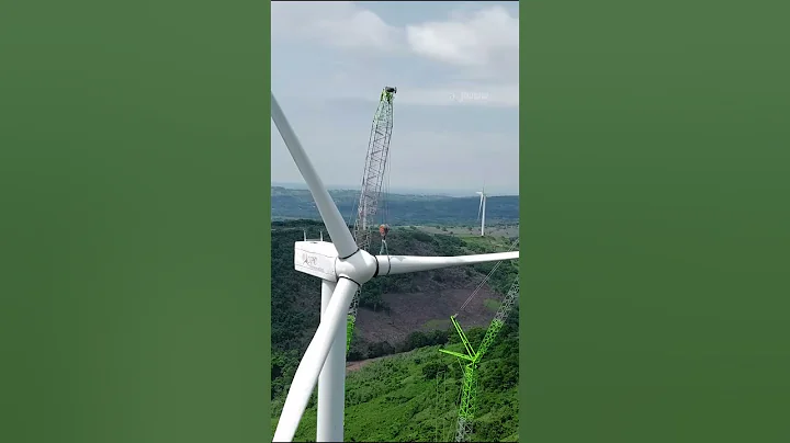 Aerial Footage movement crane & showing a line wind turbines standing in indonesia