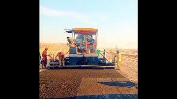 Laying of Asphalt base course inprogress with Asphalt paver machine at site for new construction