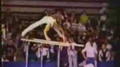 parallel bars.back uprise to support + cut fwd. to L-sit